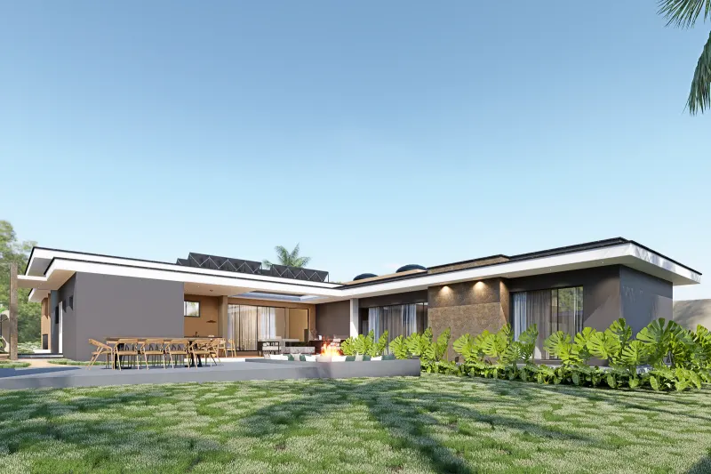 Fachada posterior da moradia térrea em L com amplo jardim e terraço