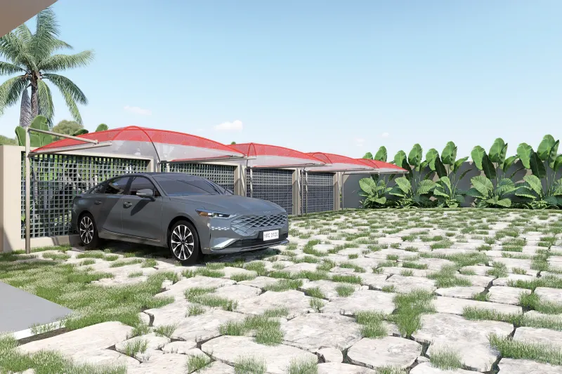 Estacionamento exterior com sombreadores vermelhos e pavimento em pedra sobre relva