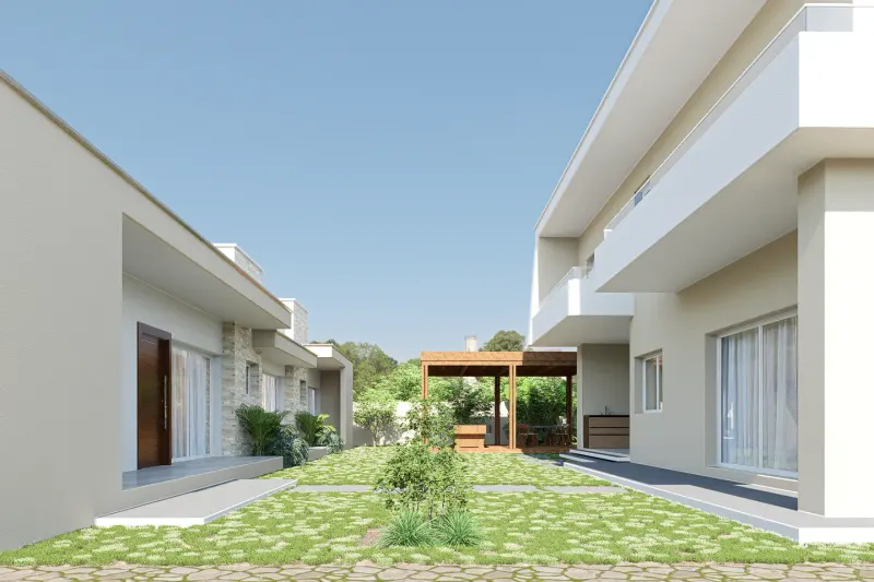 Jardim central entre edifícios residenciais modernos com relvado e pérgula ao fundo