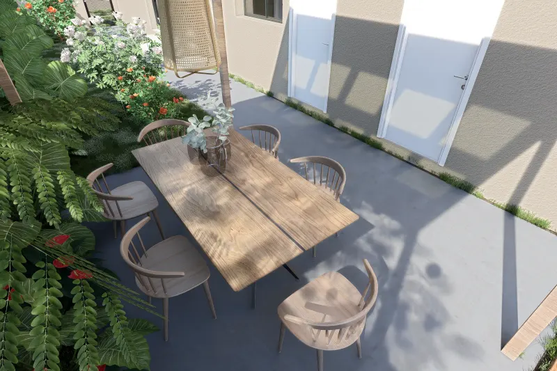 Mesa de jantar exterior sob pérgola rodeada por jardim tropical