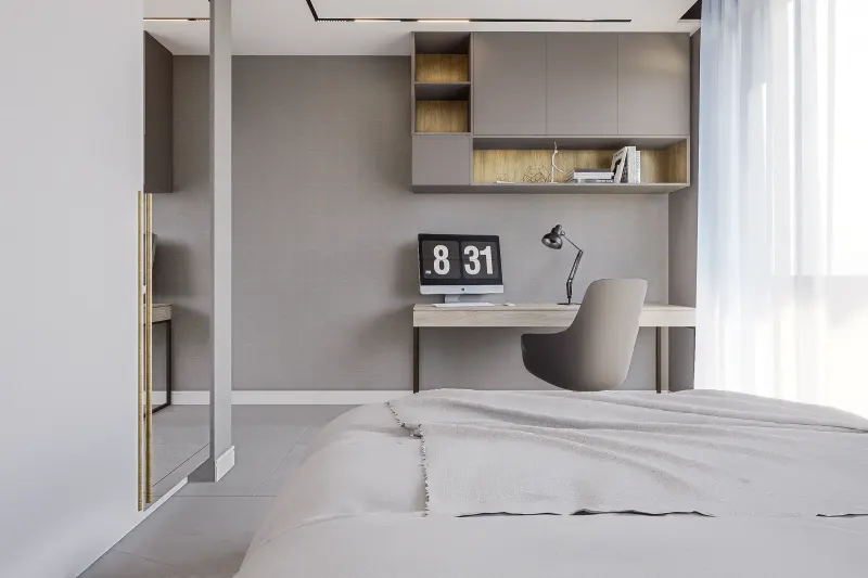 Quarto moderno em tons cinza com cama de casal e bancada de trabalho