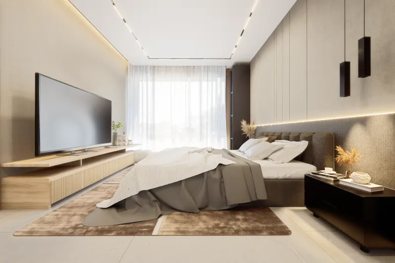 Quarto de casal contemporâneo com cama estofada, móvel de televisão e iluminação suave
