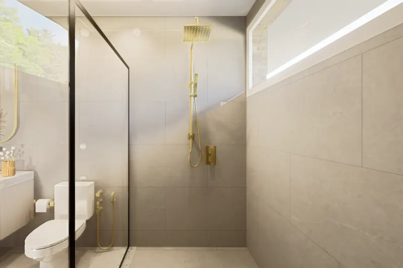 Detalhe da área de duche com chuveiro dourado de parede e revestimento cerâmico