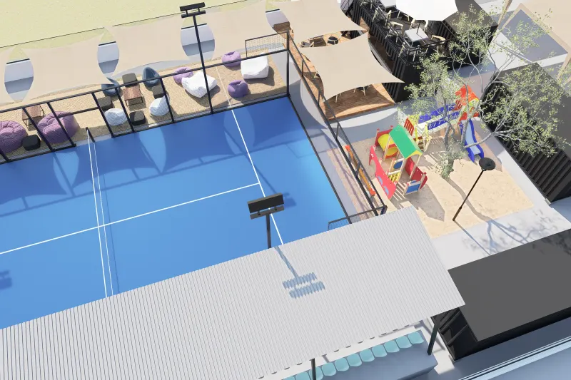 Vista aérea de conjunto com campo de padel azul e parque infantil.